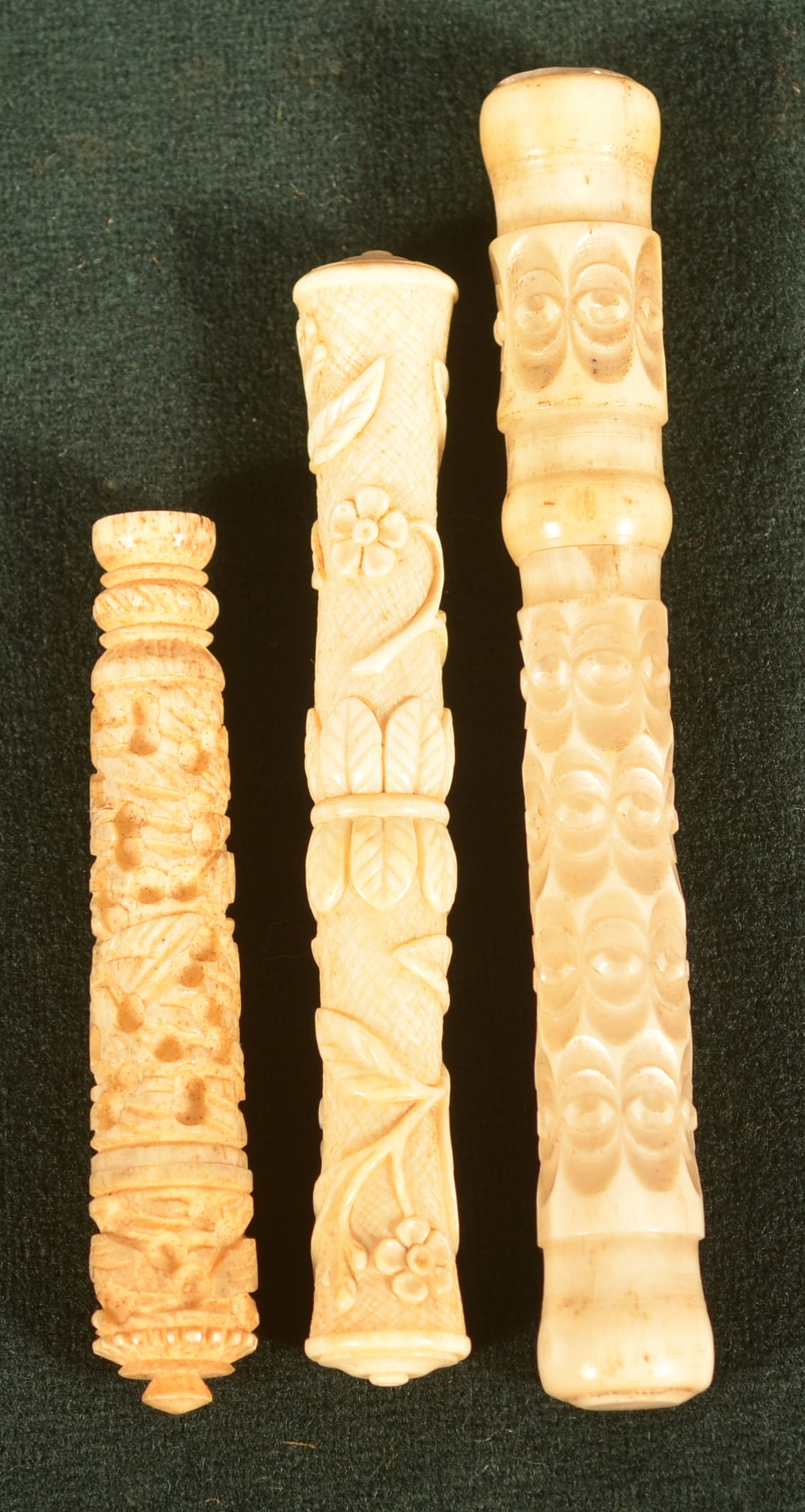 Three Chinese 19th C. Carved Bone Needle Cases.: Hand carved with various floral and berry motifs. 2-1/2" to 3-3/4"l.