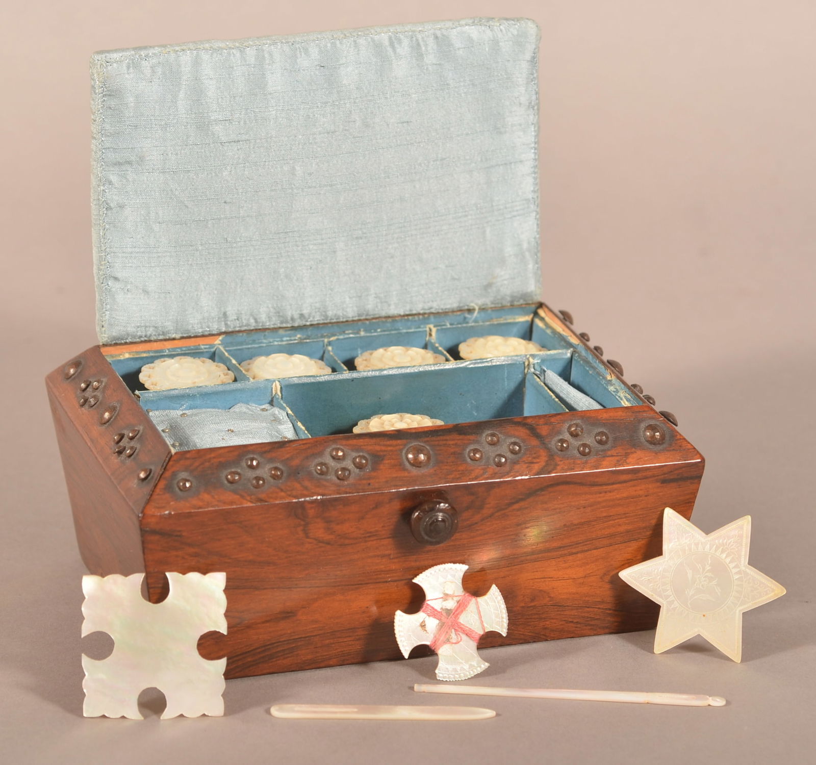 English Georgian Rosewood Sewing Box.: Polished steel tack decoration, pin cushion lid, compartmented interior fitted with Mother of Pearl and bone accessories, heavy weighted base. 3-3/4"h. x 6"w. x 4"d.