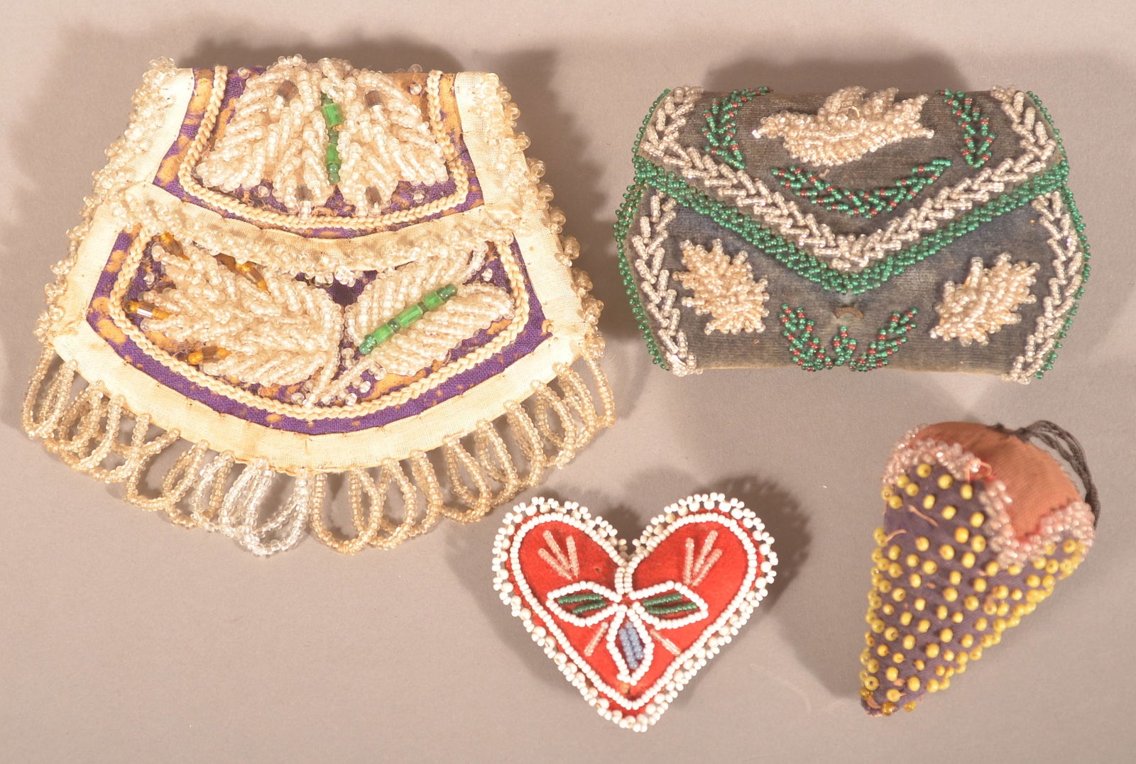 Four Antique Beadwork Sewing-Related Items.: Probably mostly Iroquois, including a needle case, small purse and two pin cushions. Purse, 4-1/2"h. x 5"w.