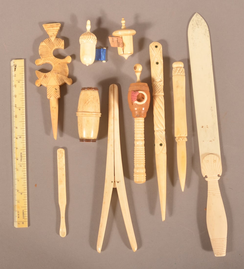 Lot of Antique Bone Sewing Tools and Accessories.: Including a glove stretcher, letter opener, tape measures, including "The Diamond Dust Soap Powder Company" Stanhope, stilettos, French 6" ruler, etc. Letter opener, 9-1/4"l.