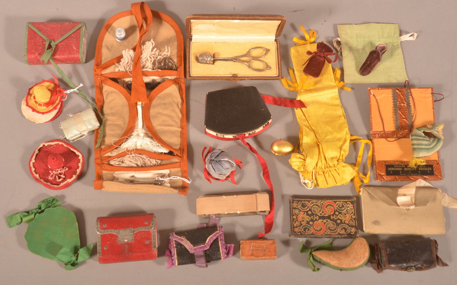 Lot of Antique Sewing Roll-ups and Needle Cases.: Fabric and leather, also pin cushions and thimble holders. Largest roll-up, 5" x 11".