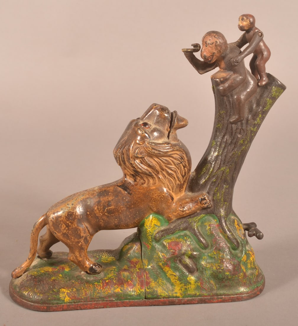 Cast Iron Lion & Monkeys Mechanical Bank.: Manufactured by Kyser & Rex Company, circa 1880s. Original paint. 9-1/4"h. x 9-1/8"l. x 3-3/4"d.