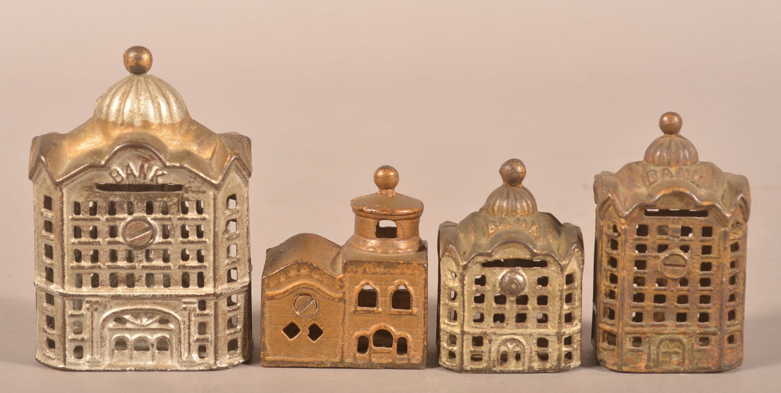 Four Antique Cast Iron Building Banks.: All with cupolas. Largest, 4-3/4"h. x 3-1/4"w. x 2"d.