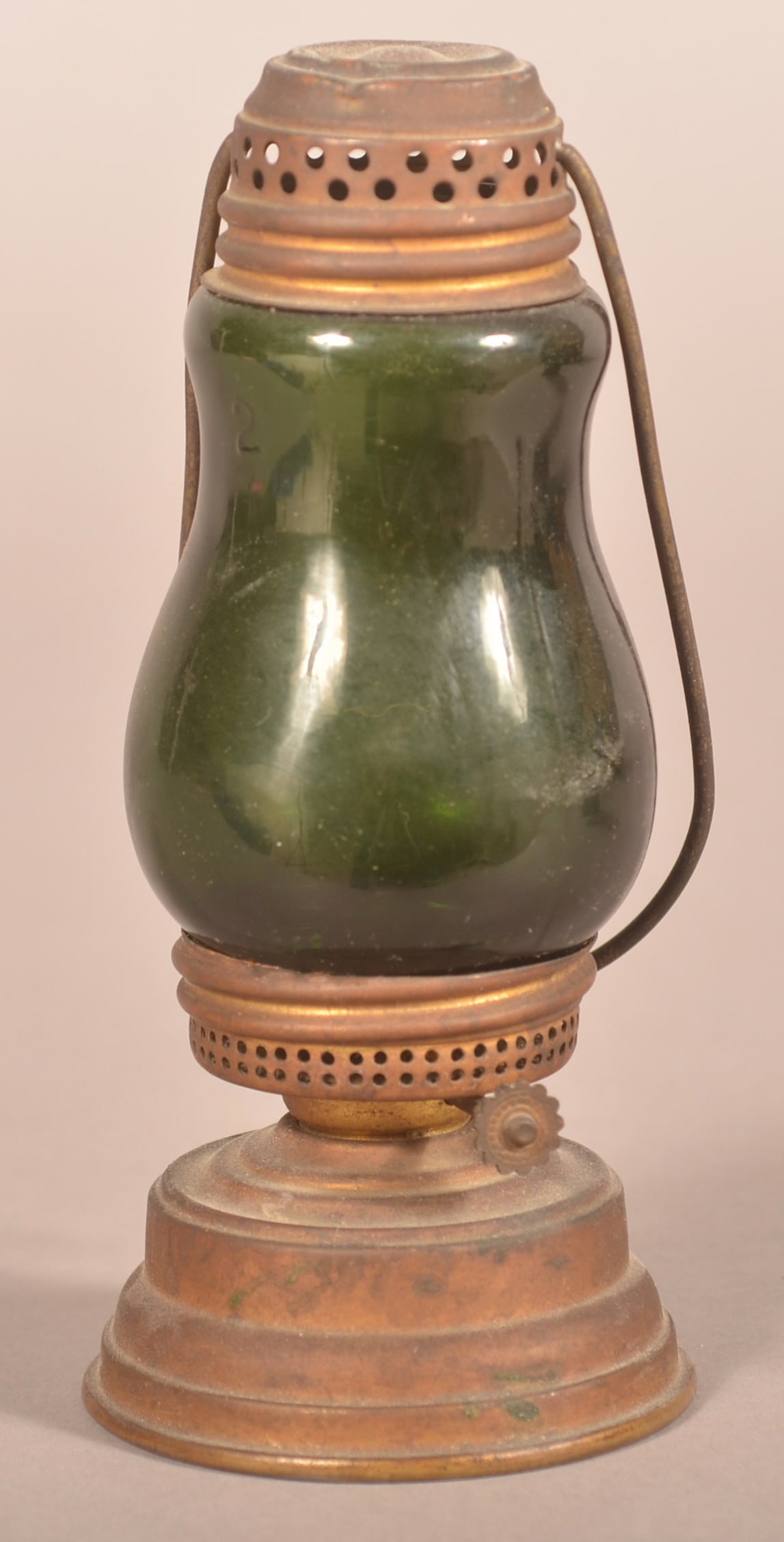 Brass Skater's Lantern with Green Glass Globe.: Perforated screw-on cap and font with bail swing handle. 7"h. x 3" diam.