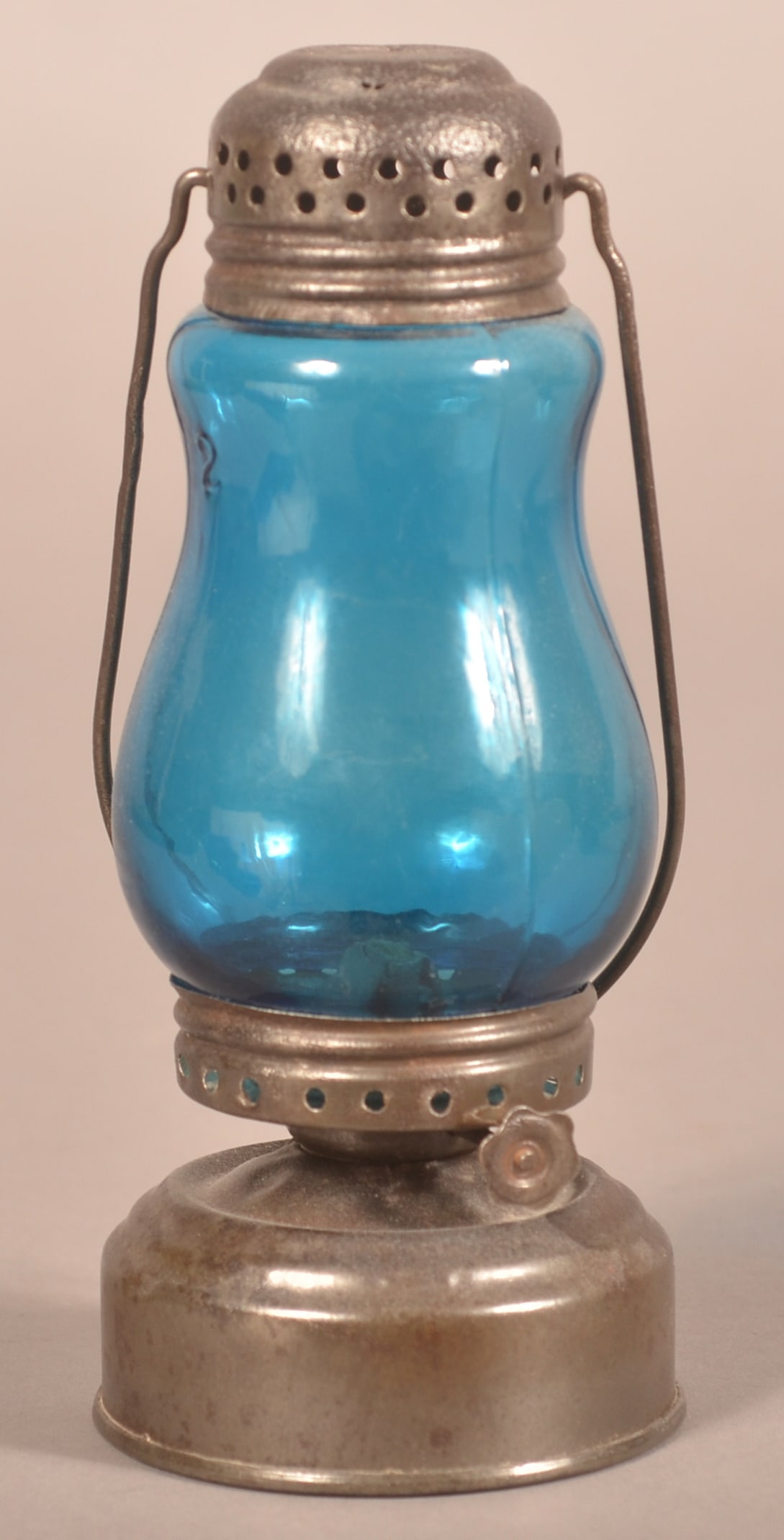 Tin Skater's Lantern with Blue Glass Globe.: Perforated screw-on cap and font with bail swing handle. 7"h. x 3" diam.