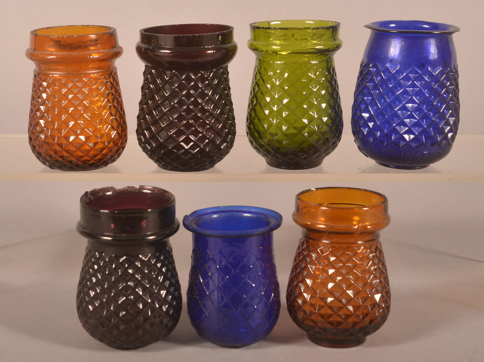 Seven Colored Glass Christmas Candle Cups.: Inverted diamond point pattern. Largest, 4"h. x 2-1/2" diam.