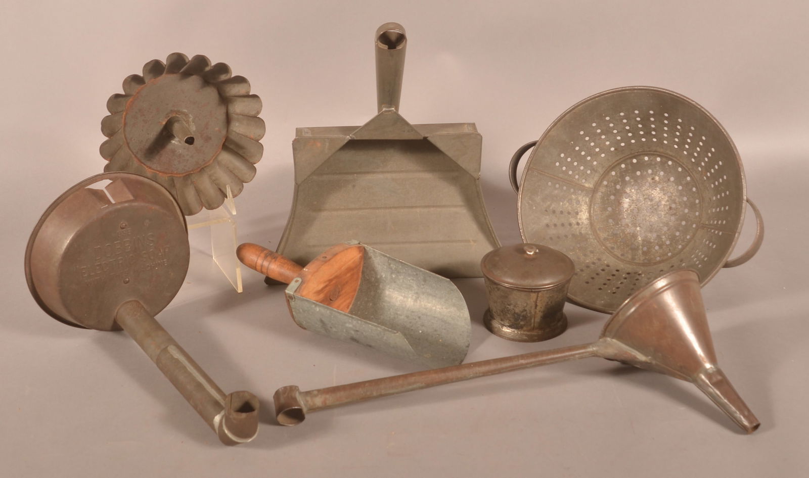 Collection Antique PA Tinware.: Seven pieces with the highlights being an unusual tinsmith-made dust pan, an embossed snorkel marked "Use Dobbins Electric Soap", and a long-handled funnel. Funnel (longest), 7"h. x 18"l.