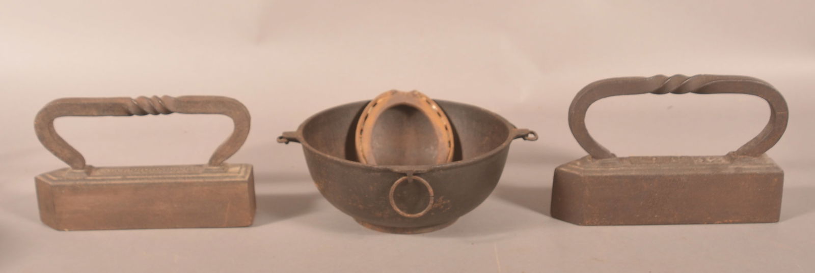 Early Sad Irons & Erie #780 Cast Iron Scotch Bowl.: Two sad irons with rope twist handles, one marked "Coalbrookdale" the other with "12" and an illegible mark. Uncommon bowl marked "Erie 780 Pat. Mar. 10 '91" with number "2". With a horseshoe for good
