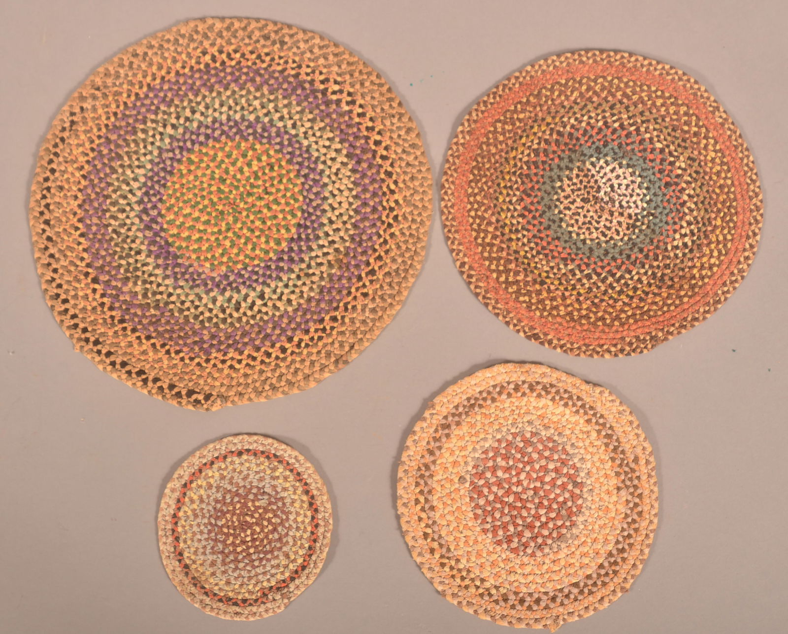 Four Round Multi-Colored Braided Table Mats. (1 of 2)