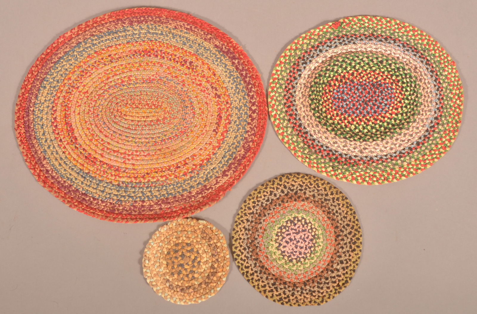 Four Round/Oval Multi-Colored Braided Table Mats. (1 of 2)