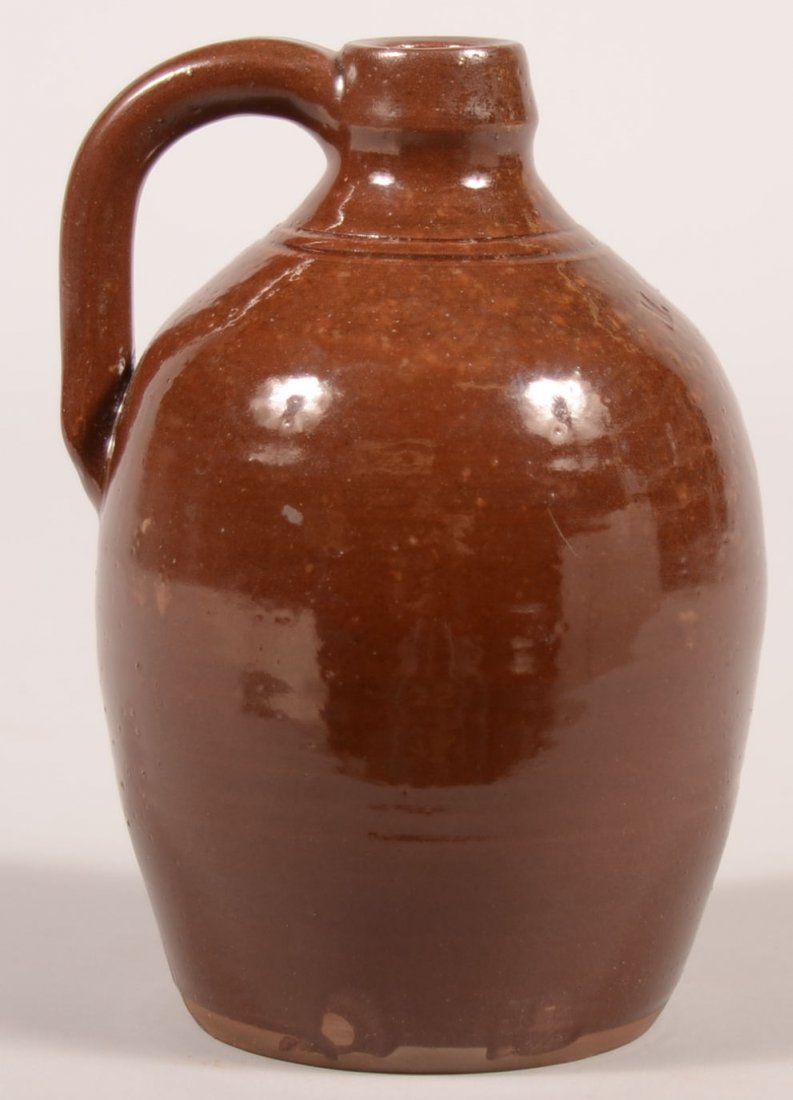 41-A. M. Presher Redware Pottery Ovoid Jug. Stamped opp: 41-A. M. Presher Redware Pottery Ovoid Jug. Stamped opposite loop handle. 7" high. Condition: Very good.