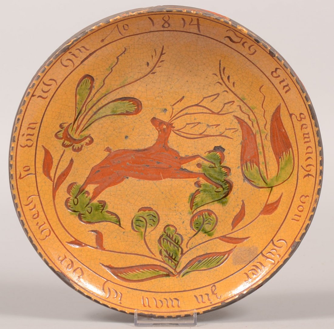 65. Greg Shooner Redware Pottery Plate Dated 2000. Sgra: 65. Greg Shooner Redware Pottery Plate Dated 2000. Sgraffitto decorated with leaping stag and floral devices, also marked on border "I am made of potters pewter, when I break then I am gone, 1814". Ye