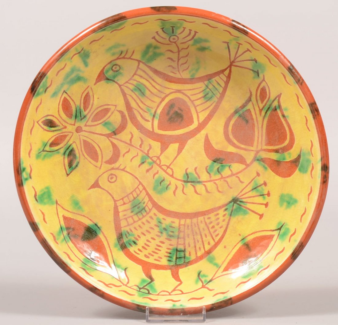 69. James Seagraves Redware Pottery Plate. Sgraffitto d: 69. James Seagraves Redware Pottery Plate. Sgraffitto decorated with birds and floral devices. Yellow glaze with green highlights. Marked on back "JS". 10 1/2" diam. Condition: Good.