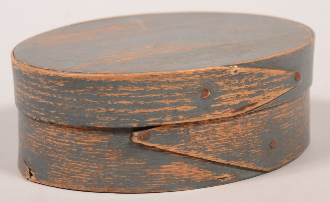 364. 19th Century Shaker Oval Pantry Box with Original : 364. 19th Century Shaker Oval Pantry Box with Original Blue/Gray Paint. Finger lapped joints with copper tack supports. 2 1/4"h. x 6"w. x 4 1/2"d. Condition: Good with paint wear.