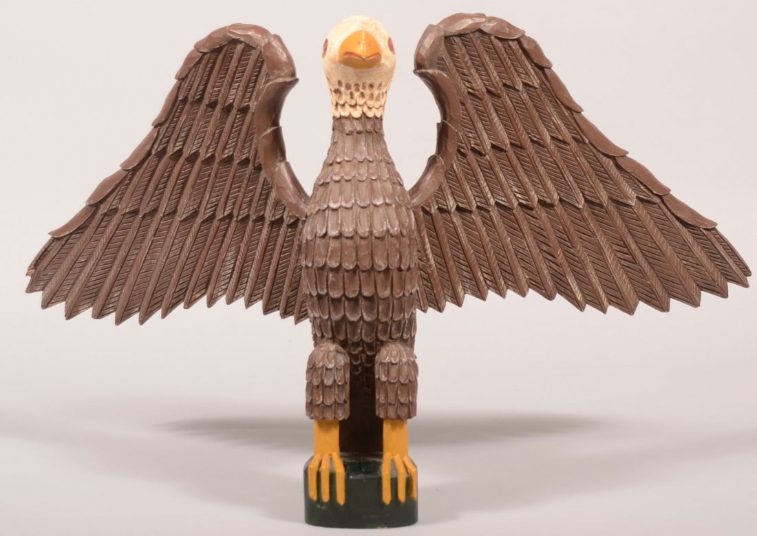 410. 20th Century Folk Art Carving of a Spread Wing Eag: 410. 20th Century Folk Art Carving of a Spread Wing Eagle. Signed "73, WESENBERG, III". Full bodied carved and painted folky American Bald Eagle. 13 3/4"h. x 23"w. Condition: Very good with tiny wing