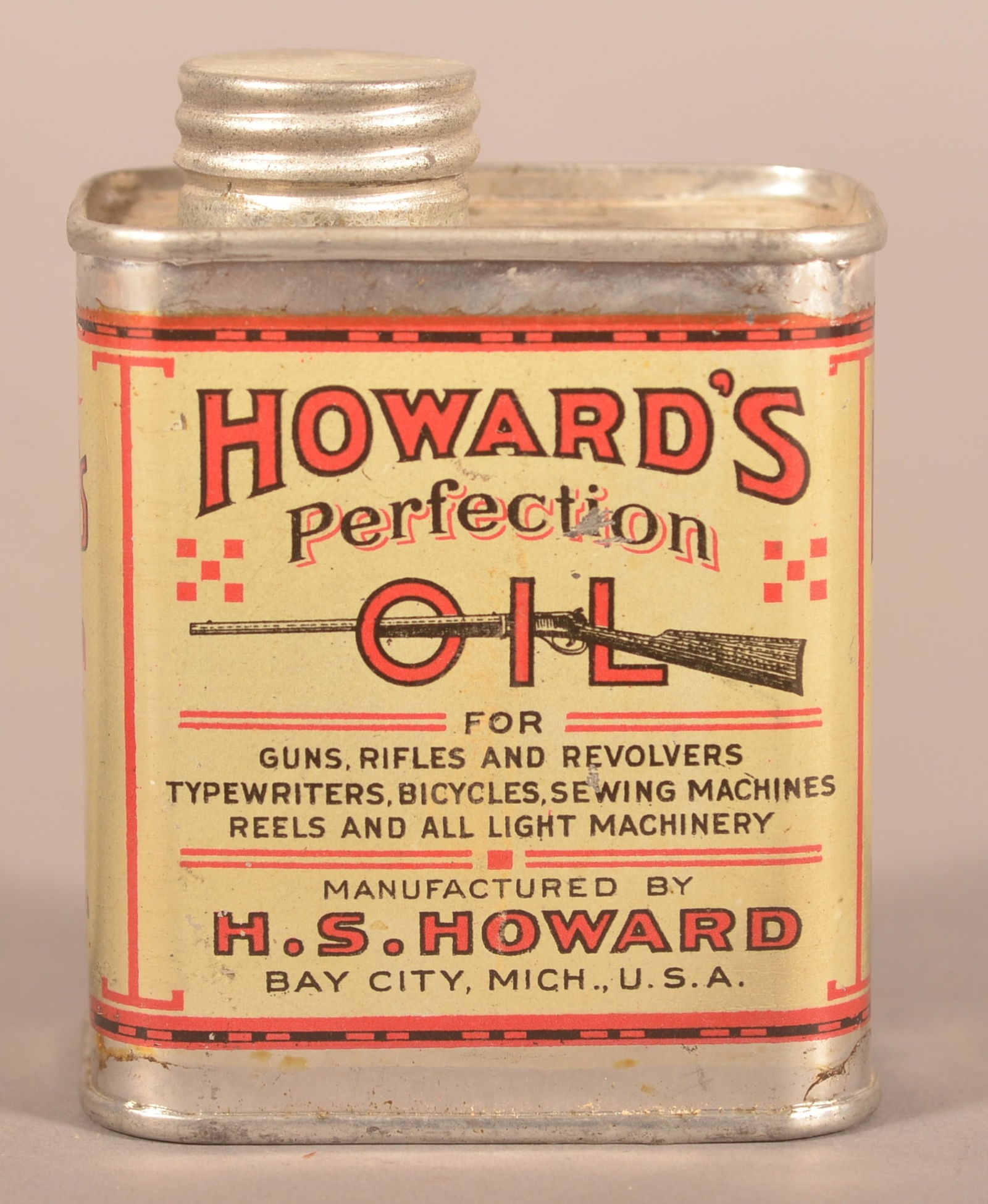 Early Howard's Perfection Gun Oil Tin.: Excellent gloss and graphics with advertising for H.S. Howard in Bay City, Michigan. Used for guns, rifles, revolvers and bikes. Screw top lid. 3-5/8"H