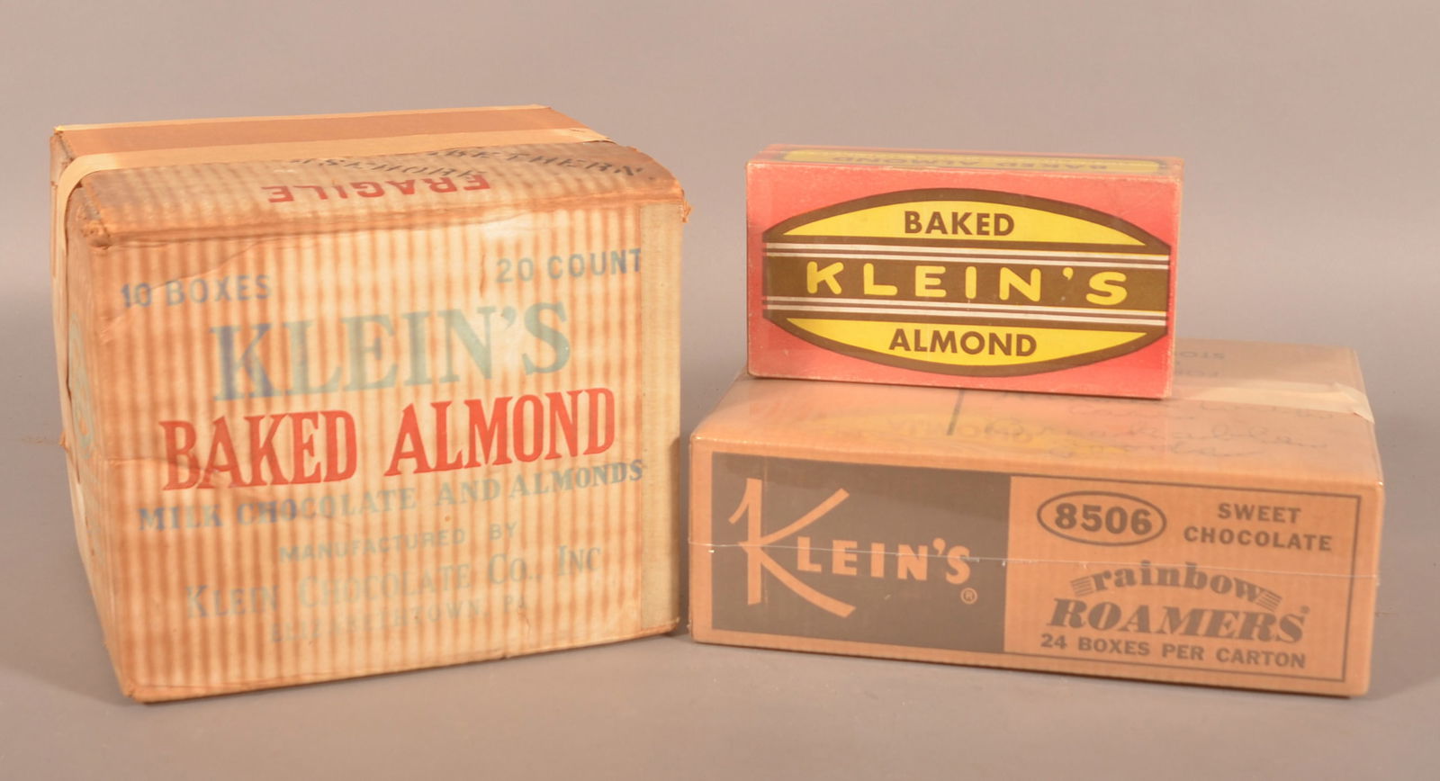 Three Klein's Chocolate Cardboard Display Boxes.: Two shrinkwrapped. Two for baked almonds and one for rainbow roamers. Provenance: James Hoffman Collection. Largest, 9-1/2"H x 11-1/4"W x 10-1/8"D