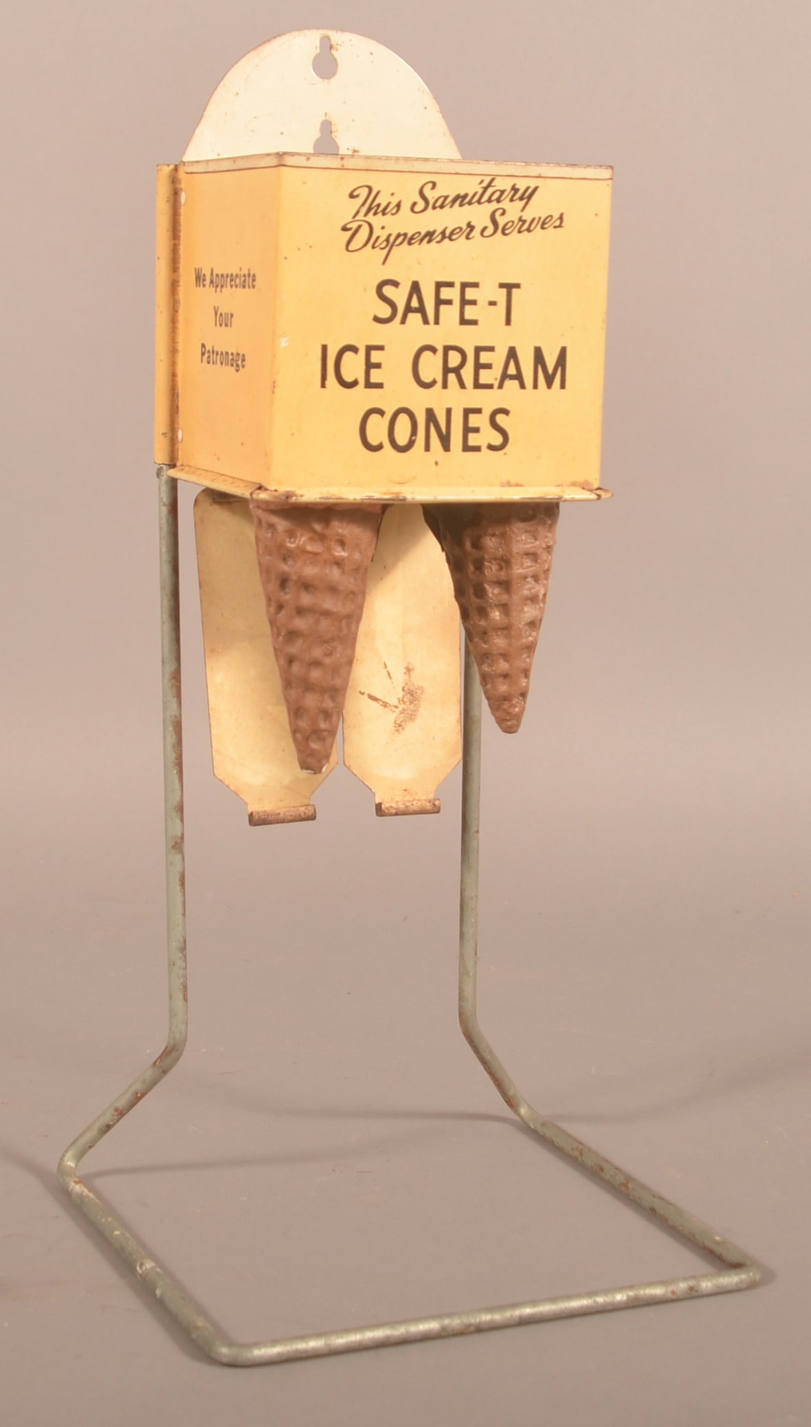 Antique Sanitary Safe-T Ice Cream Cone Dispenser.: Nice metal display meant to hang or sit on the soda fountain counter. Marked on back "Leased By Illinois Baking Corporation Chicago". With two plastic ice cream cones. 19-1/4"H x 9"W x 9"D