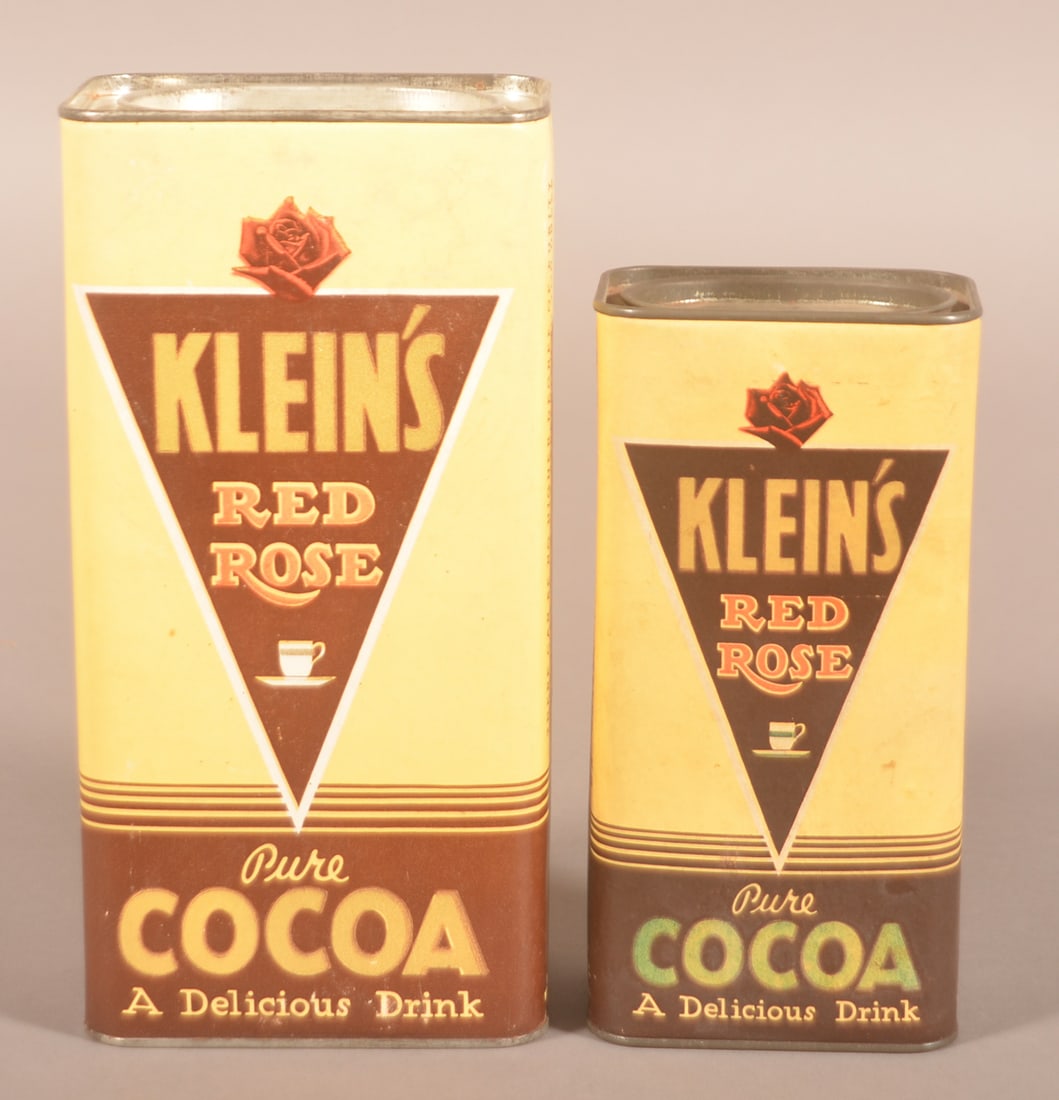 Two Klein's Cardboard Red Rose Cocoa Tins.: Cardboard body with tin ends and pry lids. Smaller with contents. Nice Art Deco colors and graphics. Provenance: James Hoffman Collection. Larger, 9-1/4"H x 4-1/2"W x 3"D