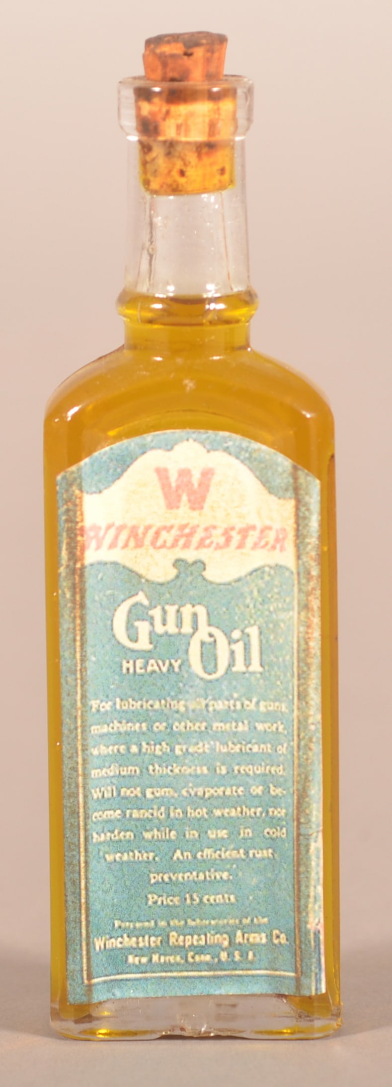 Early Winchester Gun Oil Paper Label on Bottle.: Cork top bottle embossed 72 on base. From New Haven, CT. 5-1/4"H