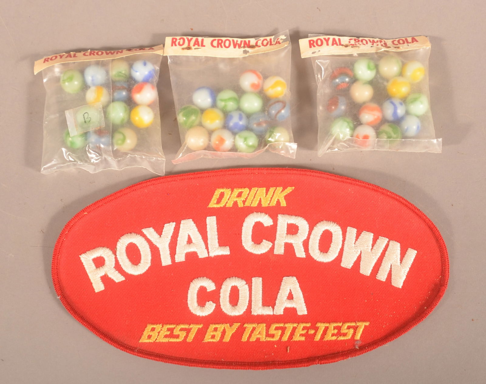 Royal Crown Cola Vtg. Embroidered Patch & Marbles.: Three unopened packs of marbles and a large patch from a delivery man's jacket. Patch, 5"H x 10"W