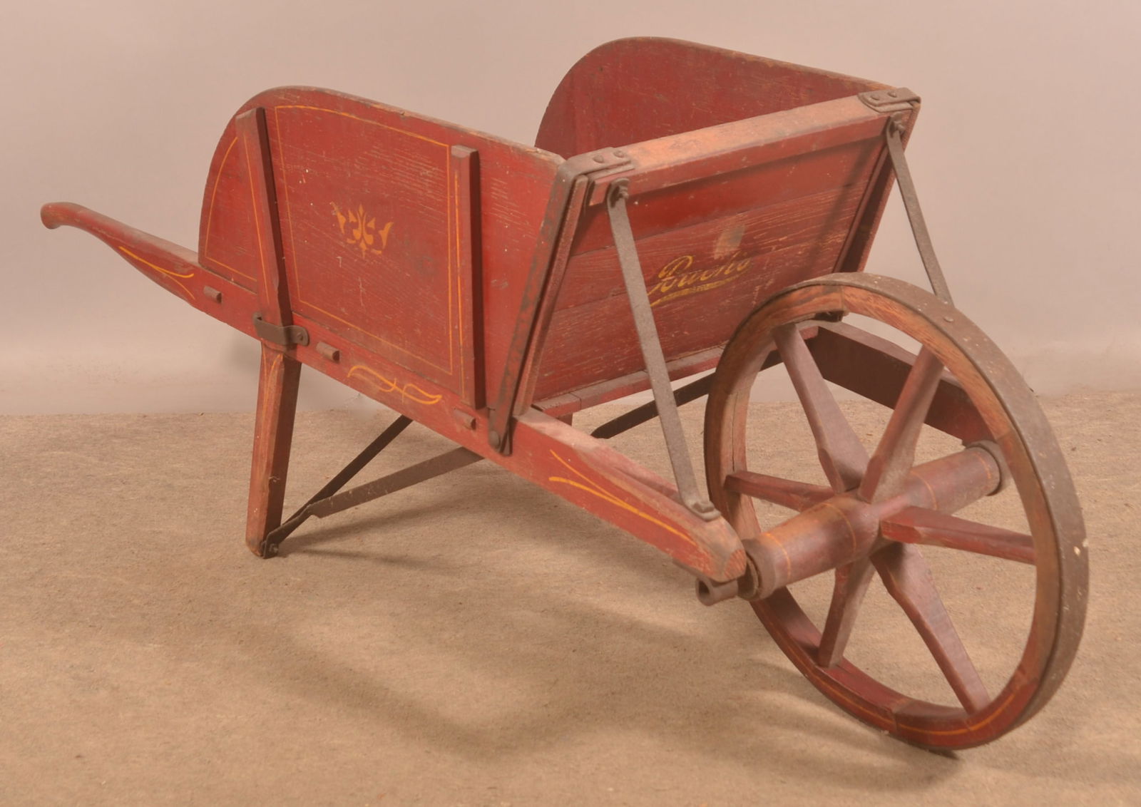Early Buch & Sons Elizabethtown. PA Wheelbarrow.: Nice variation with a different-style stencil on the front board and no number. Wood wheel and removable sides. Nicely shaped spokes. Original paint. Provenance: James Hoffman Collection. 26"H x 67"L
