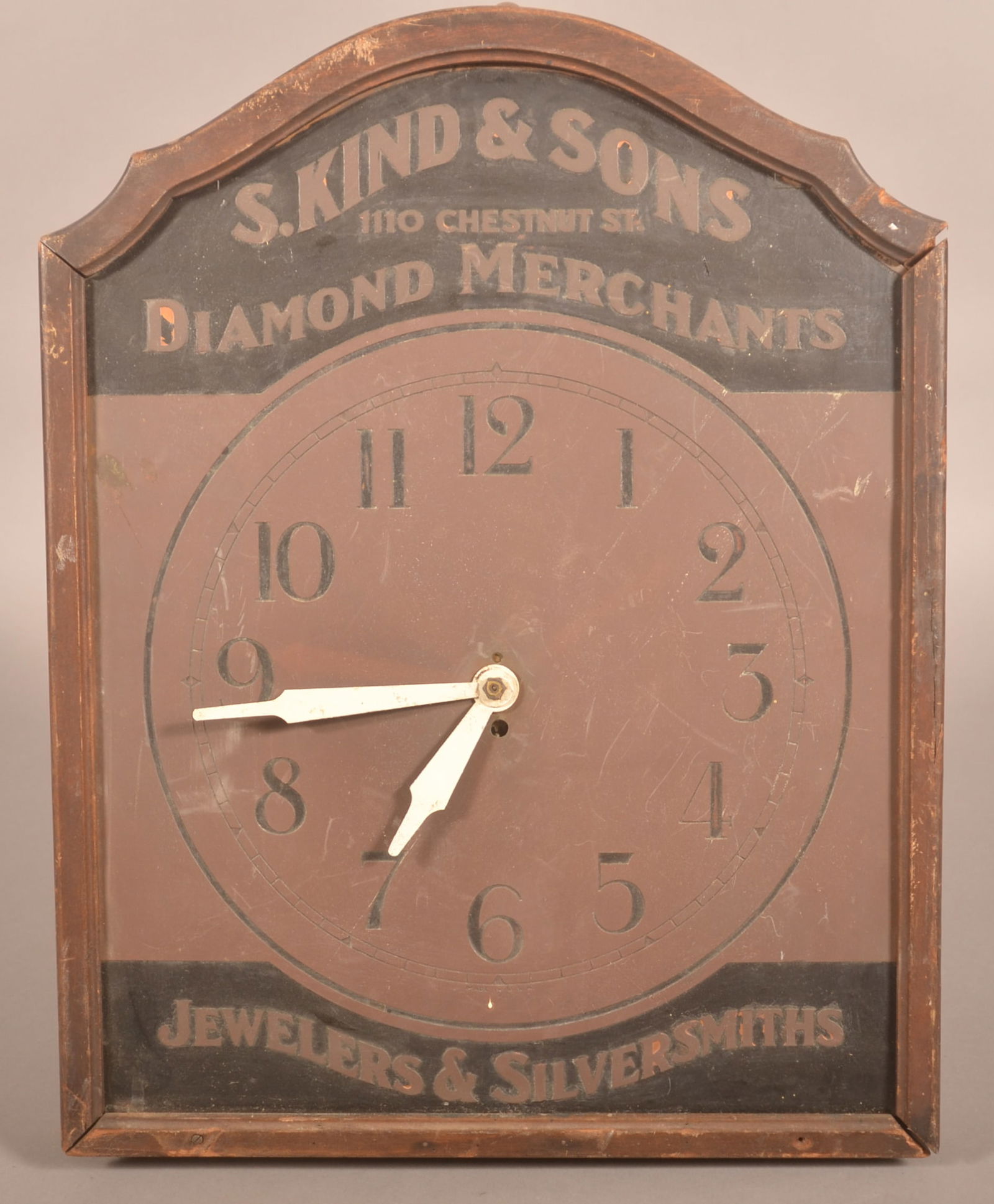 Unusual S. Kind & Sons Copper & Brass Wall Clock.: Arched-top advertising clock from well known Philadelphia jewelers. Brass and copper clock face with wood frame. Marked S. Kind & Sons 1110 Chestnut St (Philadelphia) Diamond Merchants Jewelers & Silv