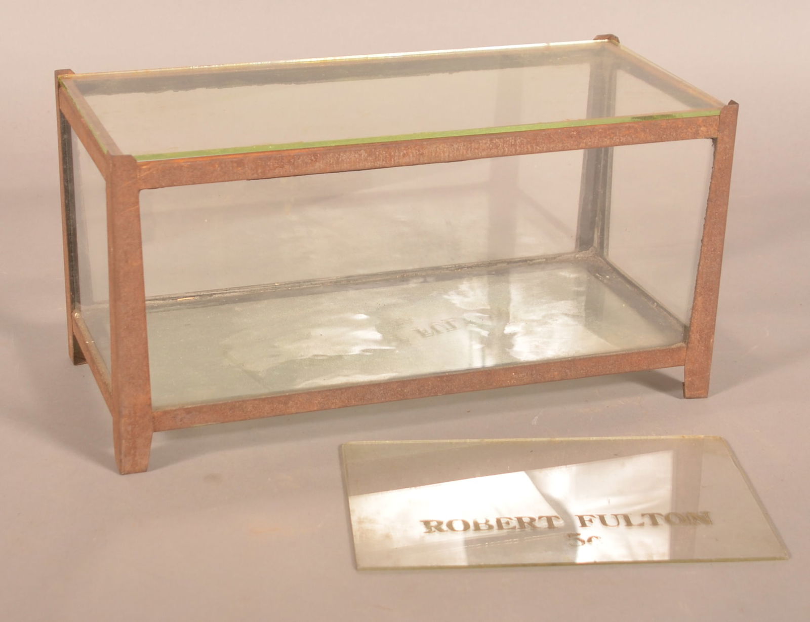 Small Countertop Chocolate Display Case.: Nice small metal frame and glass case. Case is accessed by lifting the top piece of glass. Comes with a painted Robert Fulton 5c cigar piece of glass from a display. Case, 7-1/4"H x 14-1/2"W x 6-1/2"D