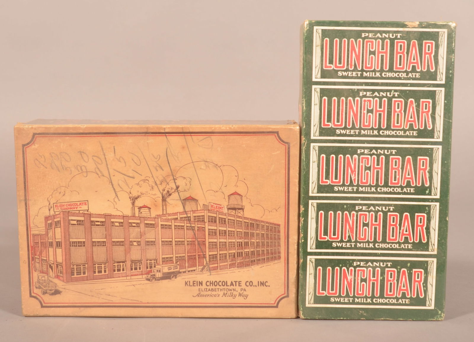 Two Klein's Chocolate Lunch Bar Display Boxes.: One box with nice image of the factory in Elizabethtown and the other with red, green and white graphics. Provenance: James Hoffman Collection. Largest, 6-1/4"H x 9"W x 2-1/4"D