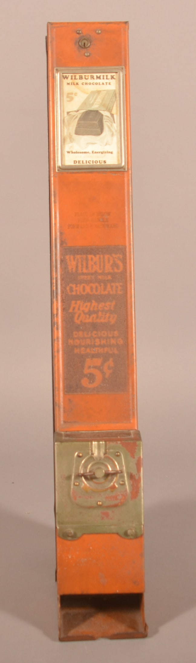 Wilbur's Hanging 5c Candy Bar Vending Machine.: 1920s. Original paint and labels. Made by the Advance Machine Co. Provenance: James Hoffman Collection. 34"H x 4-1/2"W
