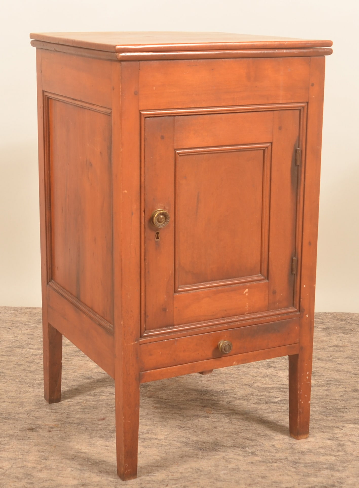 Small Sheraton Country Lift-Lid Wash Stand: Mortised and pegged construction, pine with picture frame molding around recessed panel on the door and recessed panel on back. Drawer is dovetailed. 1840-1850. 32 3/4"H x 18"W x 17 1/2"D