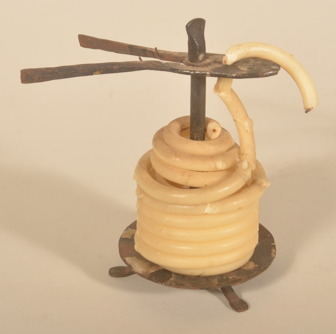 Unusual Wrought Iron Candle Form w/ Wick Trimmer: Found in Central Pennsylvania. Round base on a tripod with center post that has a thumbscrew finial that unscrews to allow the iron scissors to be removed. The wax candle looks like a beehive or coile