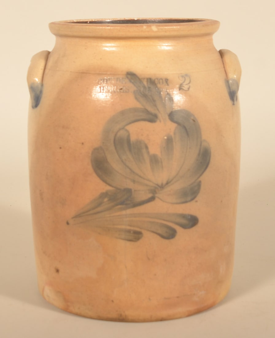 2-Gallon Cowden & Wilcox Harrisburg Butter Churn: Freehand floral decoration with impressed "Cowden & Wilcox Harrisburg PA" with capacity mark. Blue flourishes around the terminals of each handle. 12"H