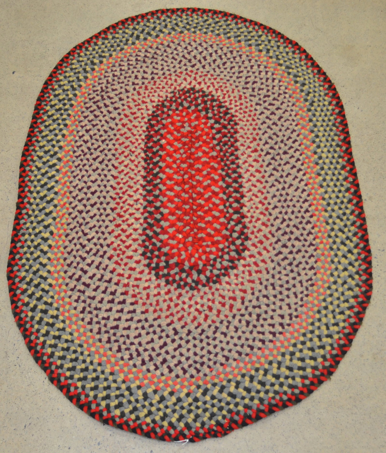 Antique Braided Rug: Braided and hand-sewn rug with warm colors. 3'6" x 5'3"