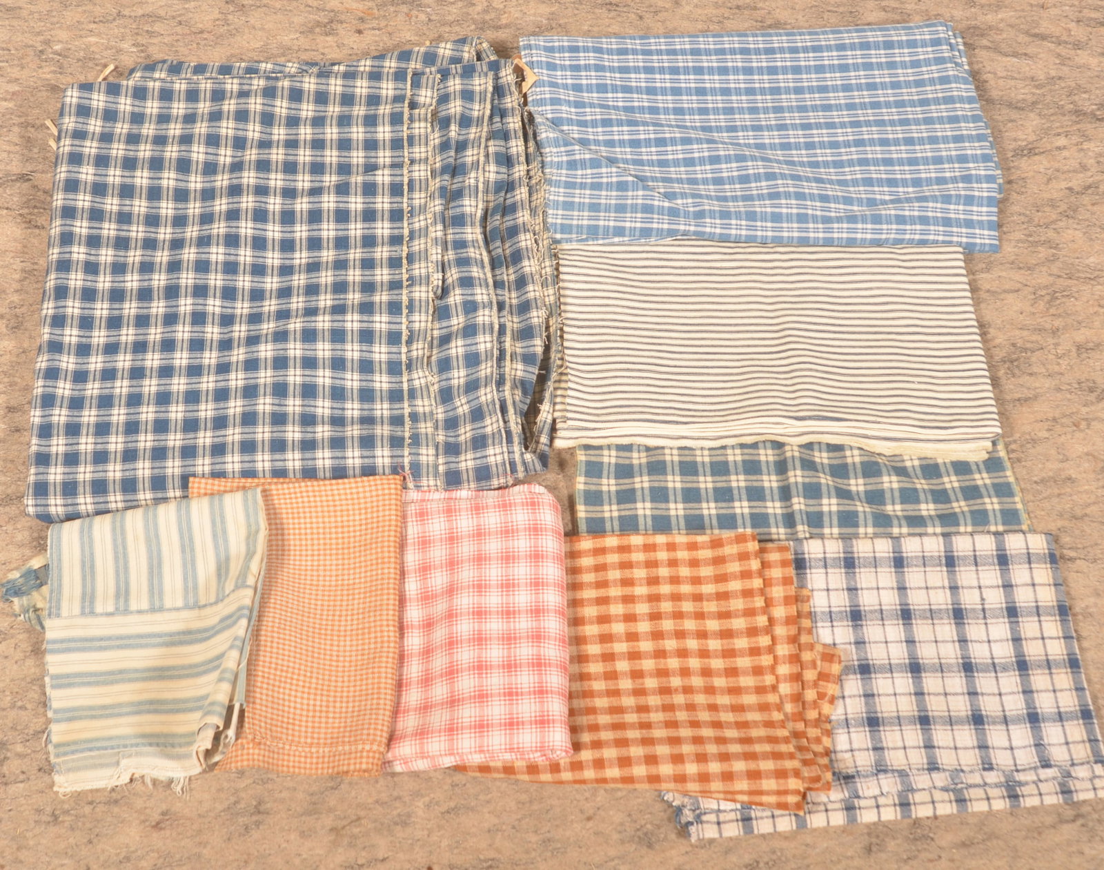 Early Brown, Blue, Red & White Homespun: 2 large pieces of brown and white homespun. 7 pieces of blue and white homespun and ticking ranging from fragment to a large section from a bed ticking and 1 piece of red and white homespun. 10 pieces