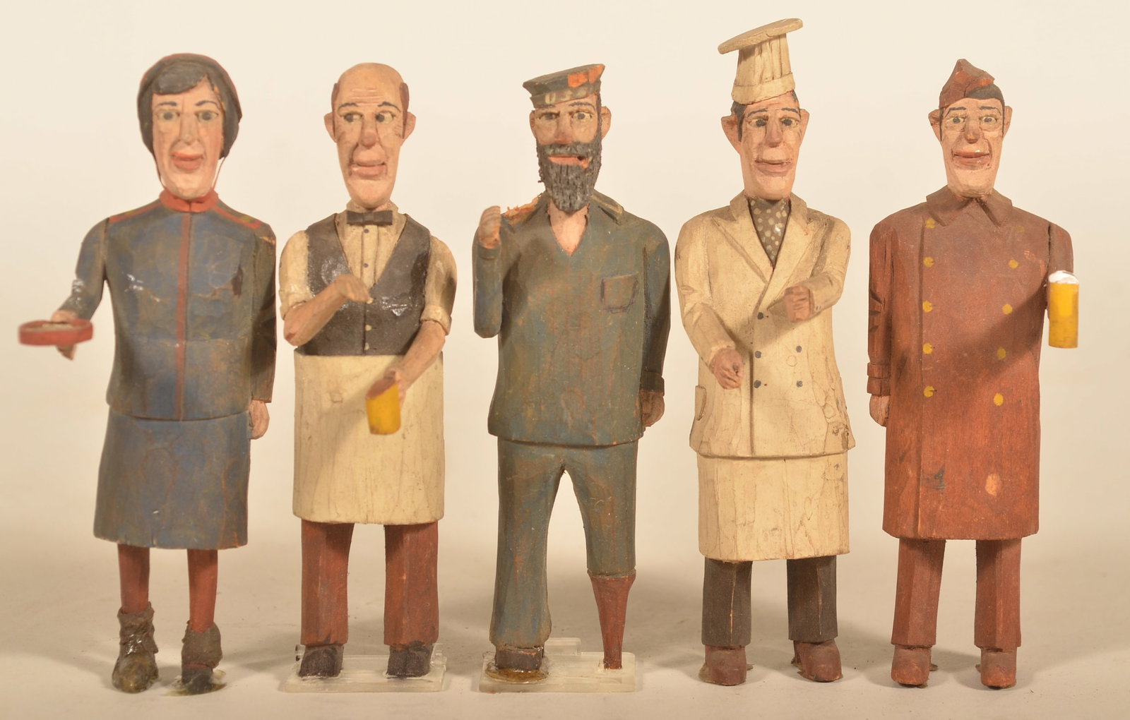 Group of Pennsylvania Folk Art Carved Wood People: Great carvings with excellent detail. WWII period based on the carved Sergeant holding his mug of beer. A pirate, chef, ticketmaster and bartender complete the grouping. Tallest, 5 1/2"H