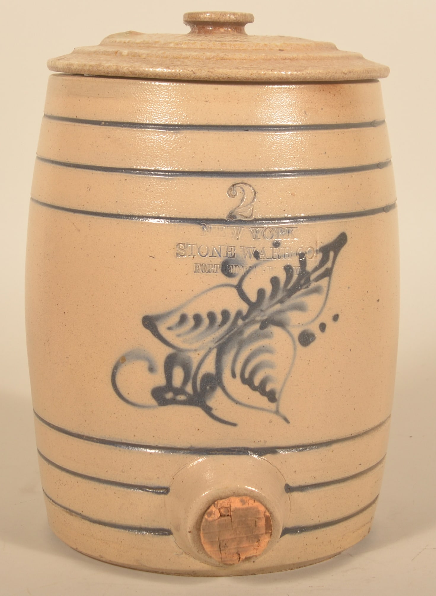 2-Gal. NY Stoneware Co Fort Edward Water Cooler: Fine example stamped "New York Stone Ware Co Fort Edward NY" and the capacity mark "2". Freehand floral decoration with additional cobalt in the tooled banding. Civil War period. With a stoneware lid.