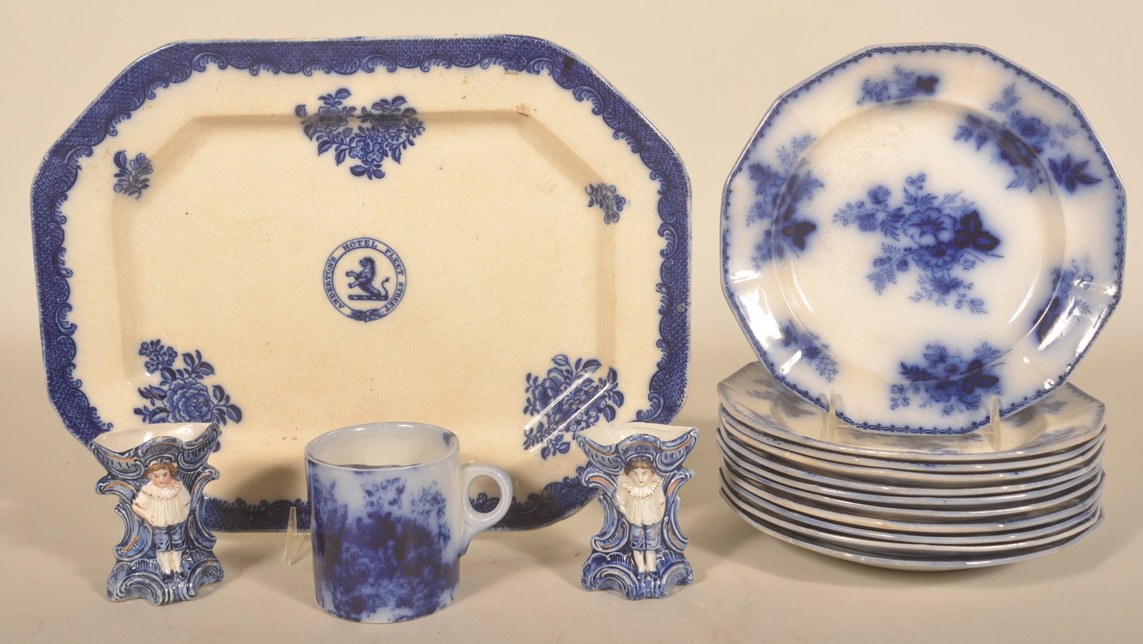 Flow Blue Ironstone China Platter, Plates & Others: 11 matching Bouquet plates marked F & W. Large platter marked Anderton's Hotel Fleet Street (1880-1939 when it was demolished) which was located in London. Marked Cobourg Stone Ware. 2 molded vases