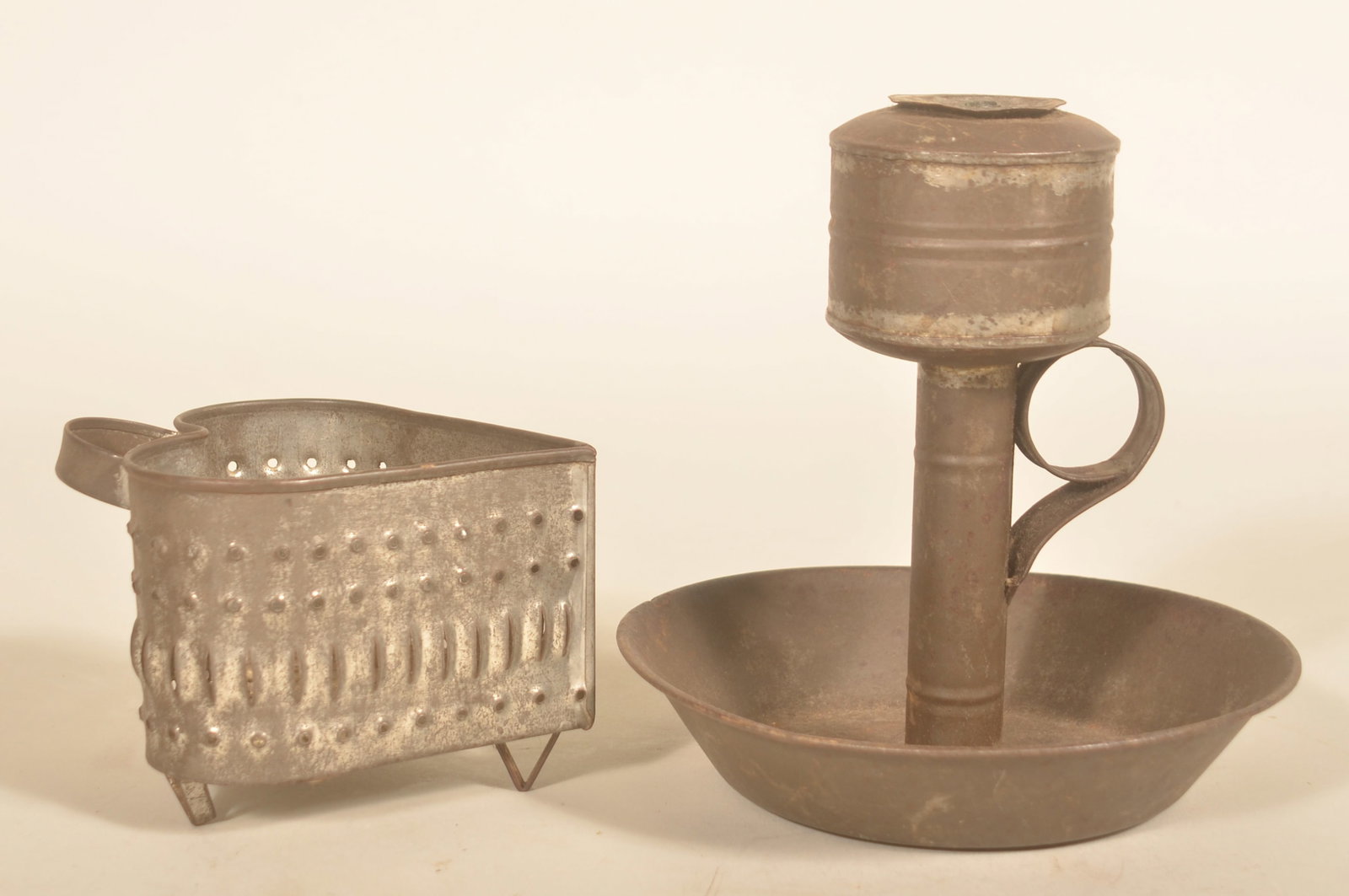 Excellent Heart-Shaped Cheese Strainer & Oil Lamp: Very nice 19th century form cheese strainer typically found in central Pennsylvania with rolled edges and triangular-shaped feet. Together with a pressed tin whale oil lamp, nice deep drip base and la