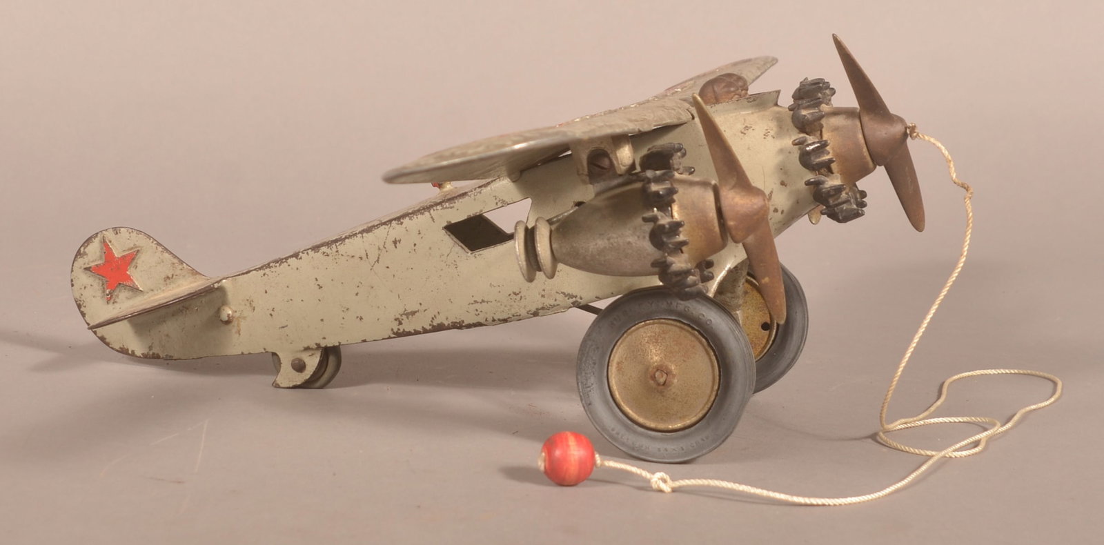 Rare Hubley Tri-Motor "America" Cast Iron Airplane: Possibly the largest cast iron airplane ever made. Produced by Hubley in the 1930s. Open cockpit with both pilots, original paint adorned with stars and the word "America" across the wing. Original ti