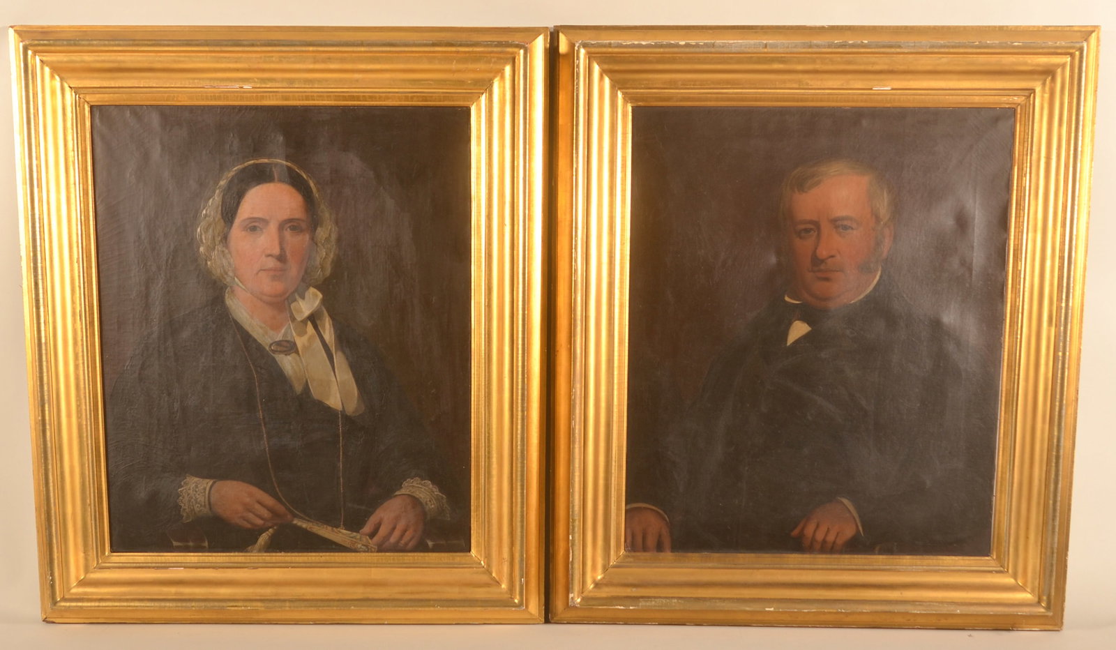 19th C. Oil on Canvas Portraits Poss. Eichholtz: A pair of mid-19th C. oil on canvas portraits of a distinguished man and possibly his wife who is holding a fan, unsigned. Original gilt frames. Possibly Jacob Eichholtz. 39 1/2"H x 34"W (overall)