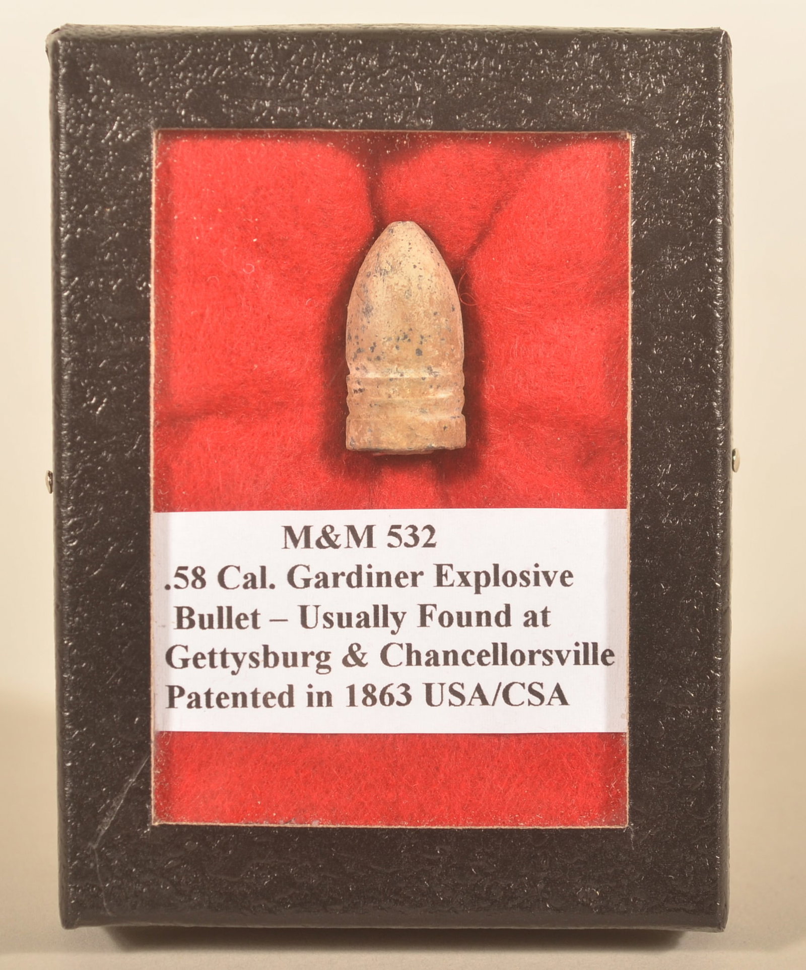 .58 cal. Civil War Gardiner Explosive Bullet: Patented in 1863 and used by both sides during the war. No notes on where this round was recovered. In Riker display case. Provenance: The collection of Craig and Cynthia Wertz. 1"L