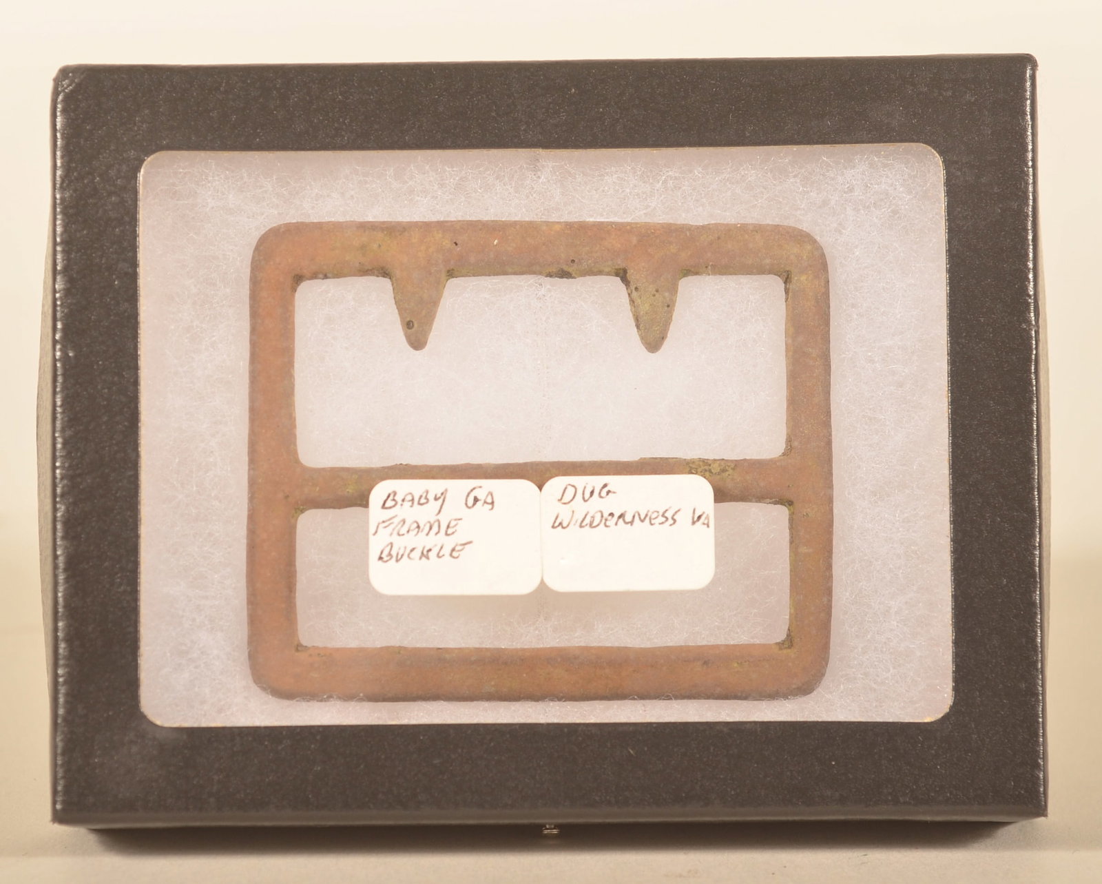 Dug Civil War Baby Georgia Frame Buckle: Sought after by collectors, this fixed tongue buckle has a beveled edge and was recovered from the Wilderness Battlefield. Provenance: The collection of Craig and Cynthia Wertz. 2"H x 2 1/2"W