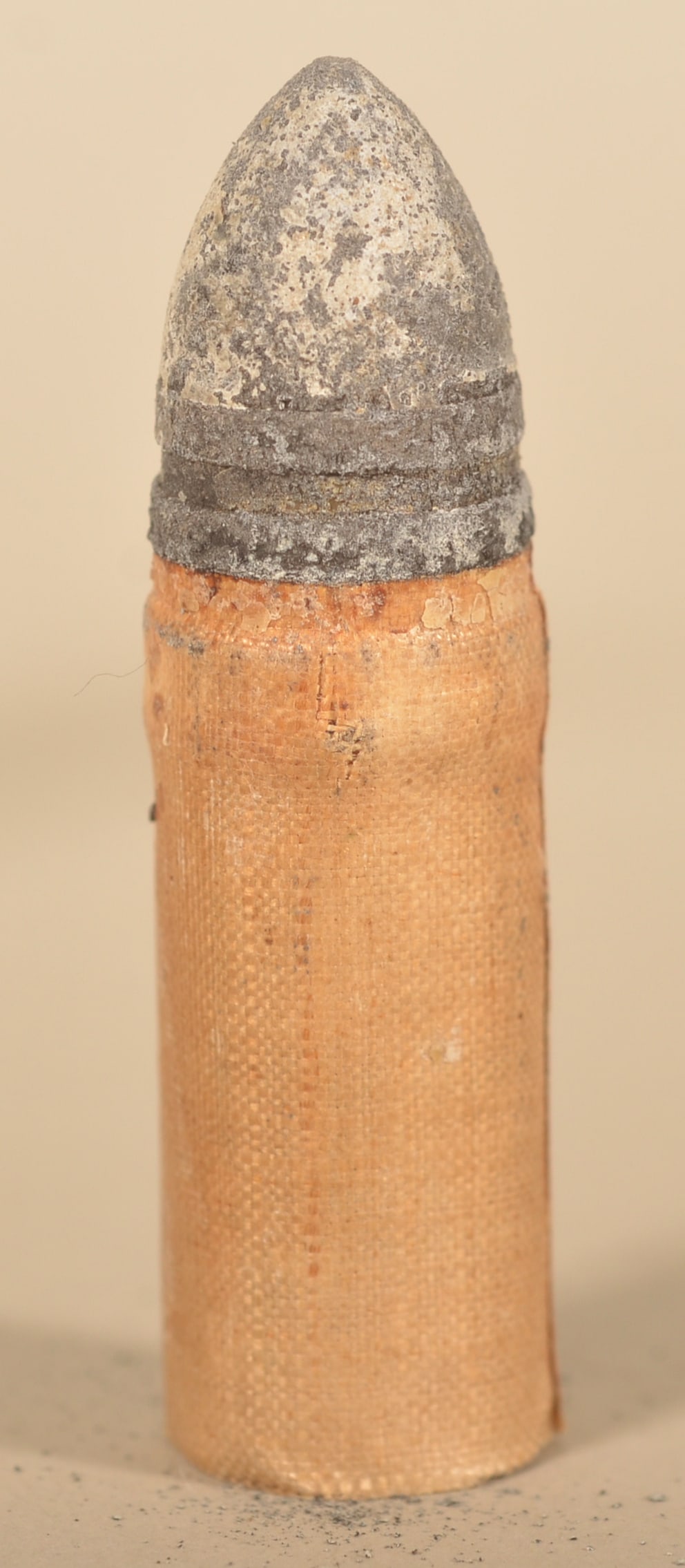 Civil War Sharps Linen Cartridge: Great example of the .54 cal. workhorse of the Union Cavalry. Conical minie ball with linen tube is intact with no dents and very good color. Retains original paper butt seal. Purchased from the Union