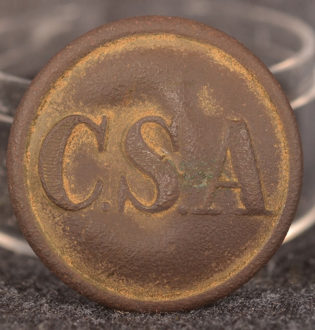 Confederate Buckley & Co "CSA" Civil War Button: Dug example with warm patina. 2-piece button marked on back "S. Buckley & Co, Birmingham". More difficult to find maker. Shank is firmly affixed. Purchased from Regimental Headquarters. Provenance: Th