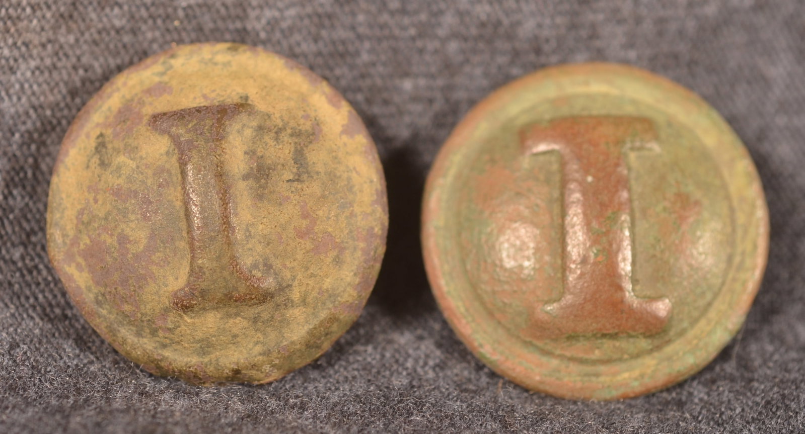 Two Dug Confederate Infantry "I" Civil War Buttons: Nice lot of two iconic Confederate infantry buttons. Raised block "I" button with warm brown and verdigris finish, solid cast brass. Collector's note that this was dug at Spottsylvania Court House. Ot