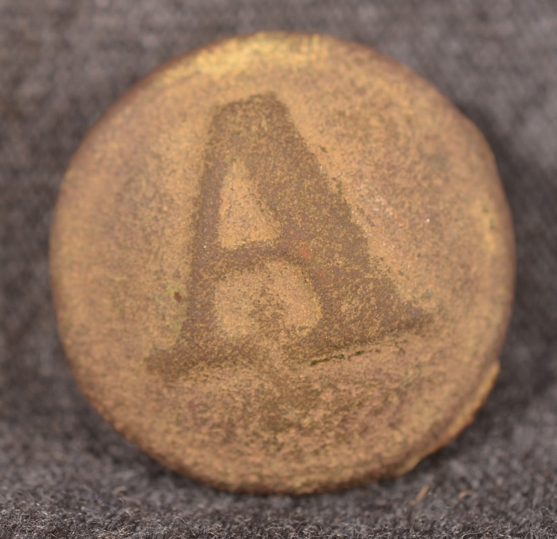 Dug Civil War Confederate Artillery "A" Button: 2-piece button with tin back retaining its shank. Provenance: The collection of Craig and Cynthia Wertz. 20 mm