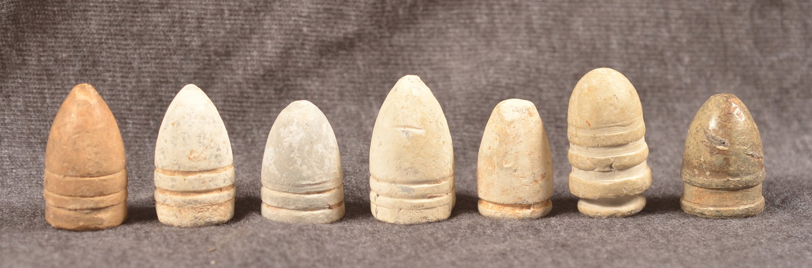 Nice Assortment Civil War Union/CSA Bullets: Seven carbine and rifle bullets including two .54 cal. Burnside carbine bullets, two .52 cal. Spencer bullets, .50 cal. blunt nose Maynard, .56 cal. Colt revolving rifle, and .54 cal. Confederate ring