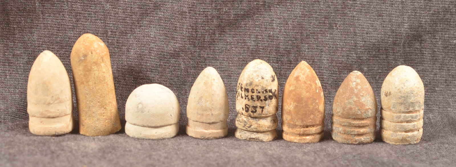 Civil War Relic Carbine Bullets: Collection of eight bullets consisting of seven carbine rounds and one shotgun slug. Group includes a .69 cal. shotgun slug, Smith/Merril/ and Sharps bullets, a .50 cal. "Stretchie carbine bullet, .54