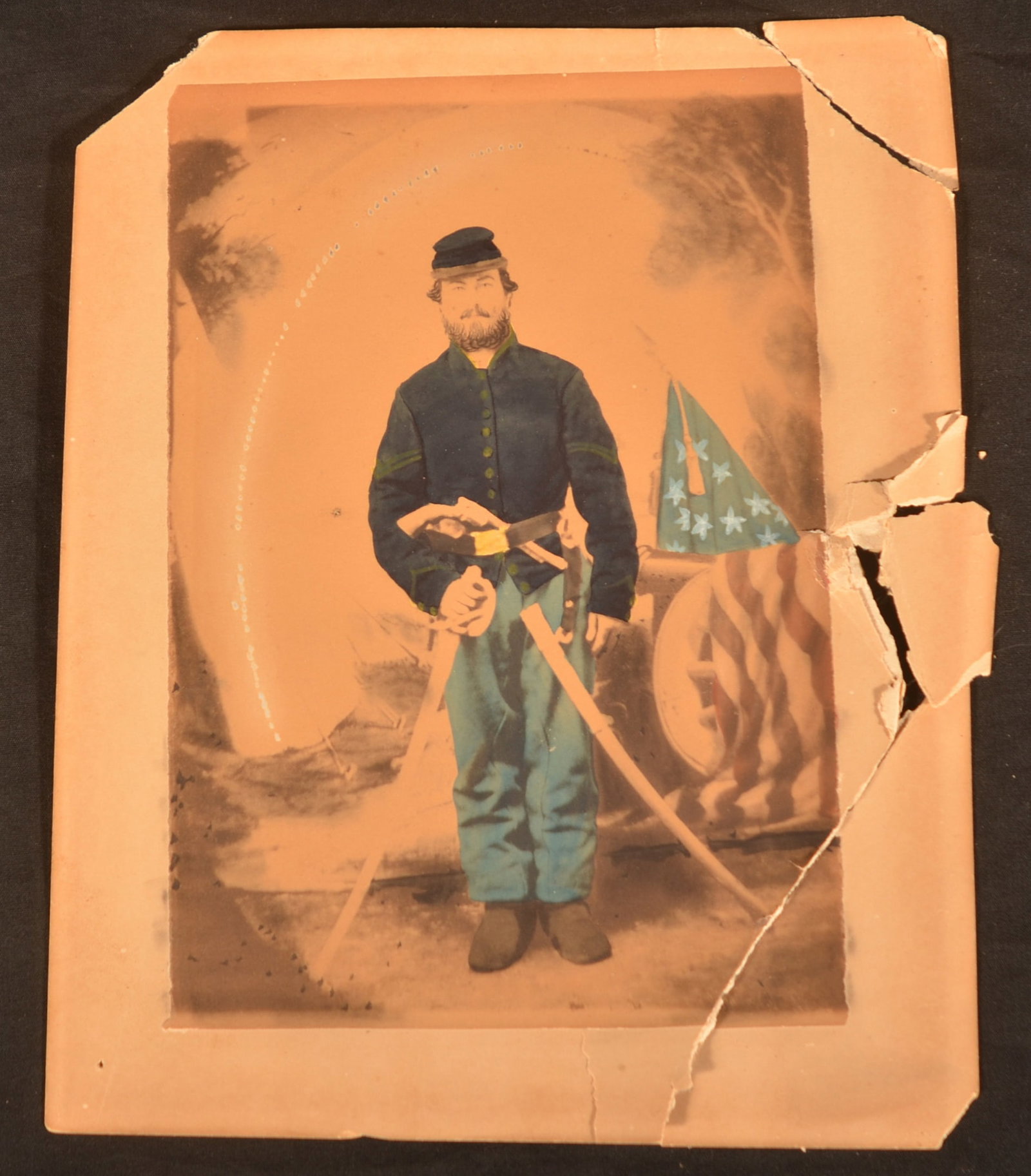 Armed 16th PA Cavalry Civil War Albumen Photo: Very nice hand-colored albumen photo (enlarged copy shot of tintype) of an armed Union corporal. Wrist breaker sword and appears to be a Colt pistol in his waist belt. Backdrop includes the US flag an